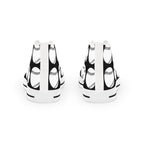 Black and white patterned canvas shoes standing on a pristine white background.