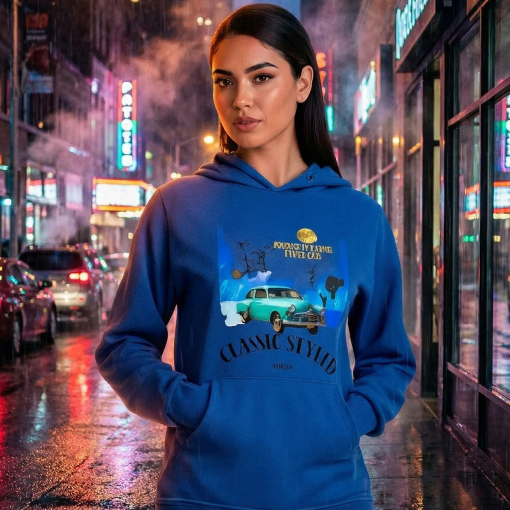 A night portrait of a woman wearing a deep blue hoodie reflecting the city lights.